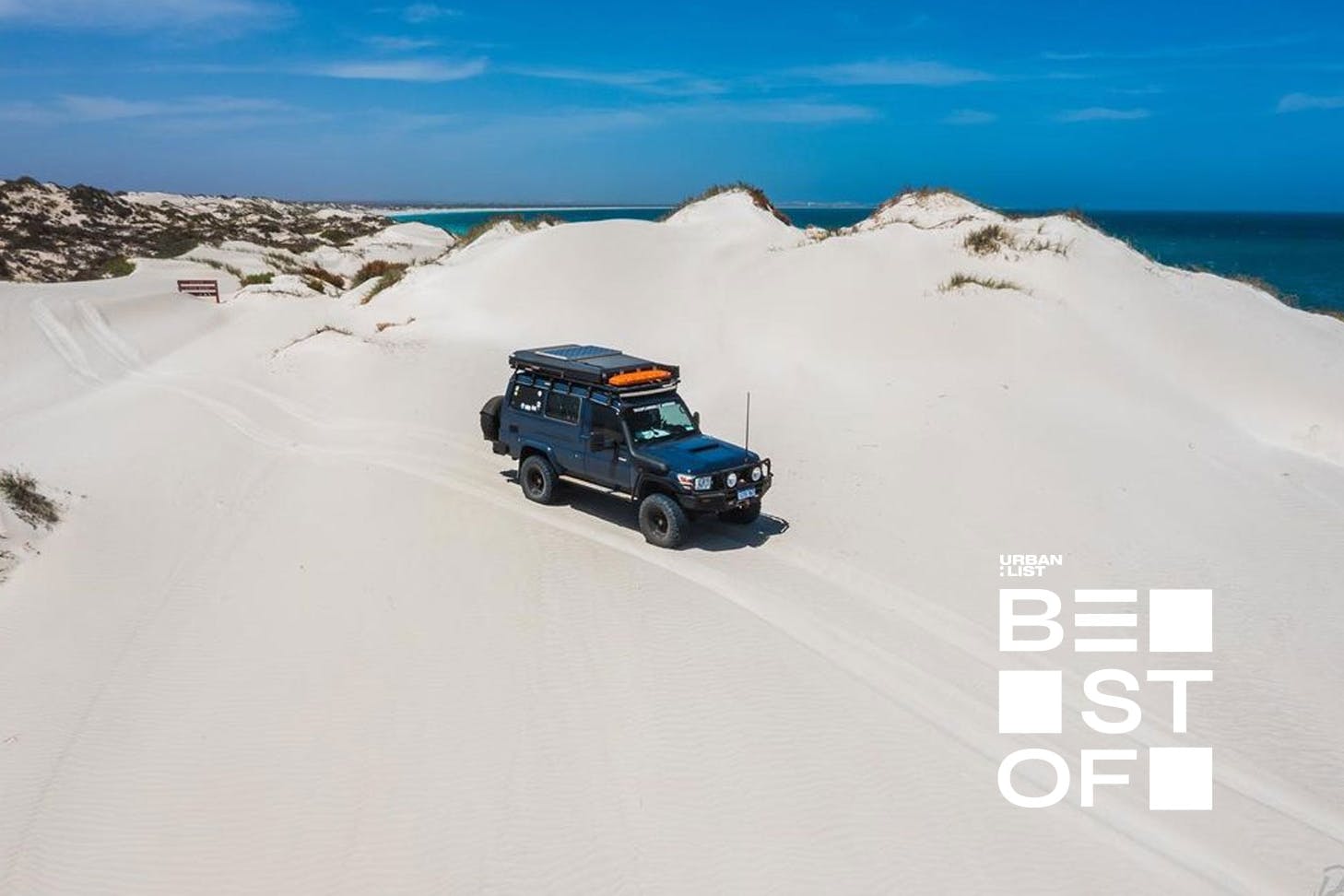 a troop carrier driving over sand